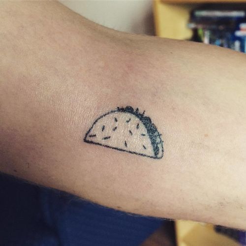 a taco tattoo on the arm of a person