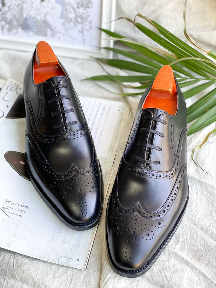 Exude timeless elegance with these Black Wingtip Oxford shoes. Crafted from premium cowskin leather, these brogues feature intricate perforations and pinking, adding a touch of sophistication to any formal ensemble. The comfortable nubuck lining and durable rubber sole ensure a confident stride, making them perfect for business meetings and special occasions like weddings. Luxury Wingtip Lace-up Business Shoes, Luxury Wingtip Lace-up Shoes For Business, Luxury Wingtip Lace-up Shoes For Office, Wingtip Oxfords With Rubber Sole, Classic Leather Shoes With Perforated Almond Toe, Business Leather Shoes With Perforated Almond Toe, Luxury Office Lace-up Wingtip Shoes, Wingtip Lace-up Shoes With Brogue Detailing For Galas, Gala Wingtip Lace-up Shoes With Brogue Detailing