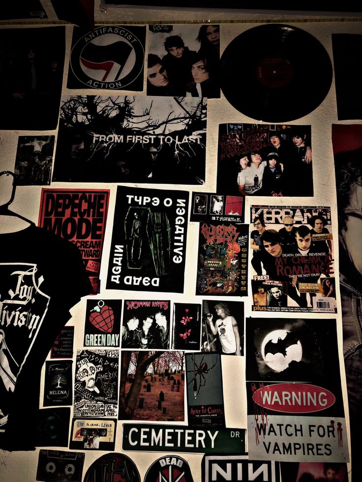 a wall covered in posters and stickers next to a record player's head