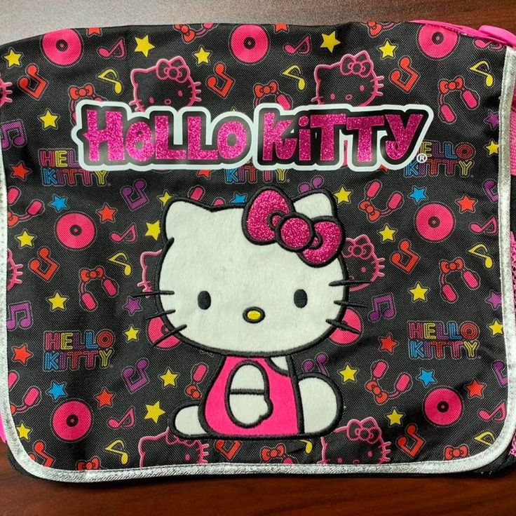 2003 Hello Kitty Messenger Bag, Bookbag, Backpack. Has A Pink Adjustable Strap At The Top And Fastens With Velcro On The Inside Of The Front Flap. Fits A 13” Macbook A Side Pouch To Hold Water Bottles, Etc. See Pics/Vid For Better Description And Approx. Measurements. (Note Bag On Vid Is The Same Size And Measurements Just Different Design) #Hellokitty #Sanrio #Powerpuffgirls #Strawberryshortcake #Messengerbag Pink Hello Kitty Print Bag For Back To School, Pink Hello Kitty Print Standard Backpack, Pink Hello Kitty Print Backpack, Pink Backpack With Cat Design, Pink Hello Kitty Standard Backpack, Pink Cat Design Standard Backpack, Pink Rectangular Backpack With Cat Design, Pink Hello Kitty Backpack, Pink Cat Design Rectangular Backpack