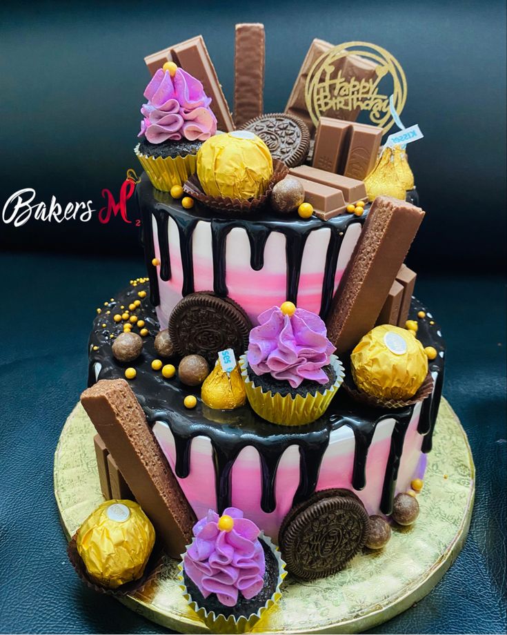 a three tiered cake decorated with chocolate and candy