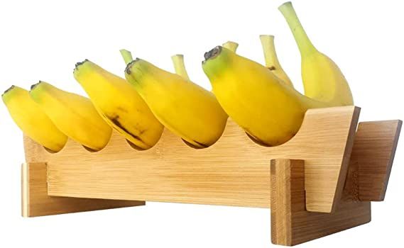 five bananas in a wooden holder on a white background