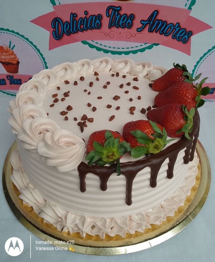 a white cake with chocolate and strawberries on top