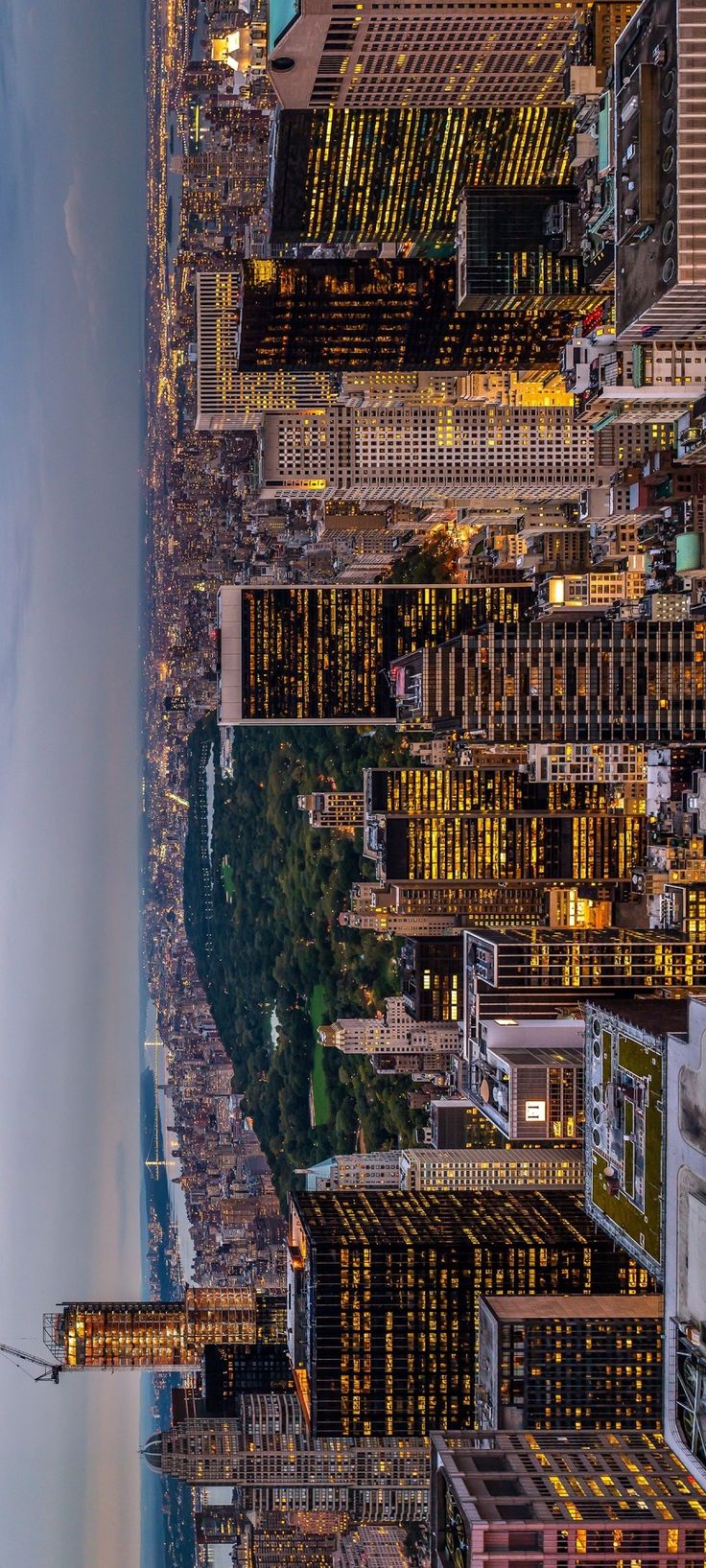 an aerial view of the city at night from above, looking down on skyscrapers