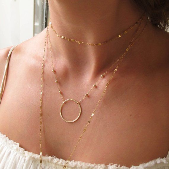 Gorgeous everyday necklace that can be dressed up or down.A glittering gold circle pendant is suspended by a 14k gold filled chain dotted with faceted 14k gold filled pieces.  The large Unity piece is hand shaped, soldered, hammered, and polished to a glittering finish.  The angular gold beading adds an edgy detail to the chain.  The hammered surface of the Unity piece allows the necklace to sparkle beautifully in any light.This is a fantastic piece to wear daily, day to night.  Perfect as a sta Delicate Gold Circle Jewelry, Gold Full Circle Jewelry With Delicate Chain, Gold Jewelry With Delicate Full Circle Chain, Simple Gold Necklace, Gold Circle Necklace, Gold Necklace Simple, Gold Circle, Everyday Necklace, Circle Necklace