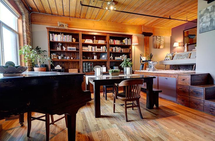 a living room filled with furniture and a piano