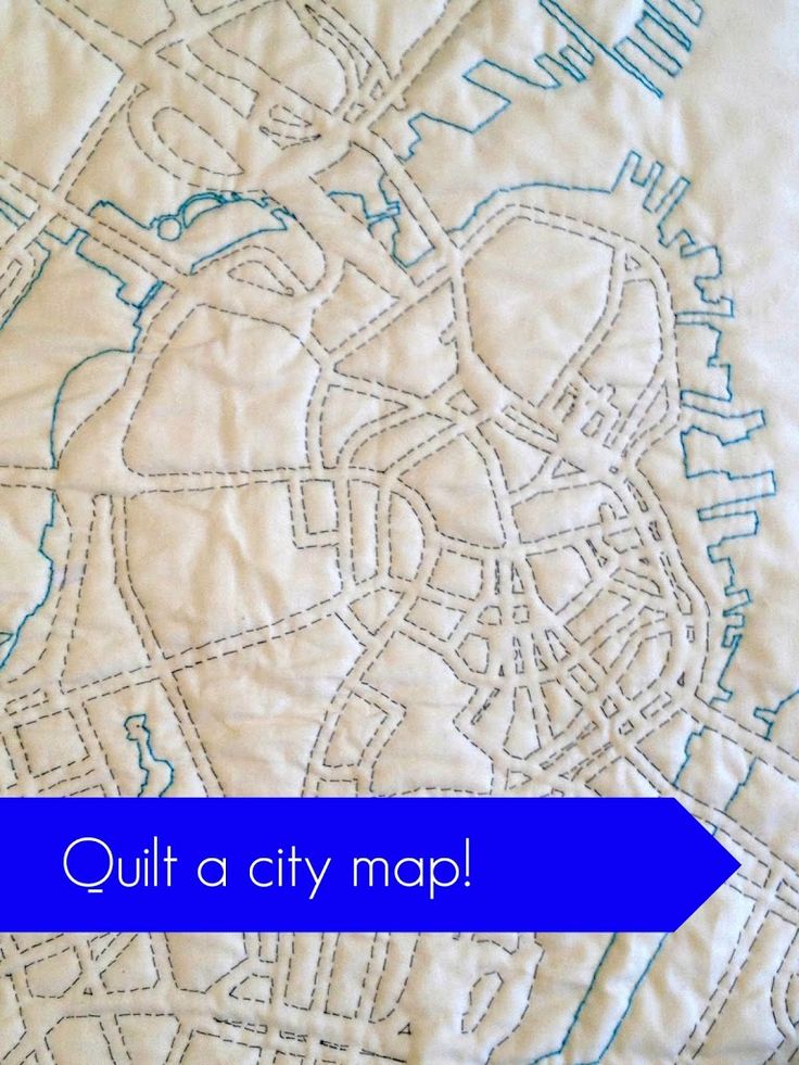 a close up of a quilt with the words quilt a city map written on it