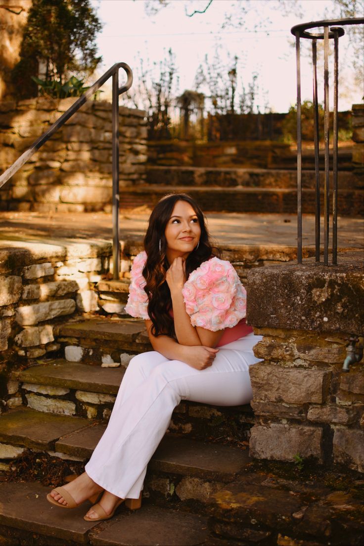 a woman sitting on steps holding a stuffed animal