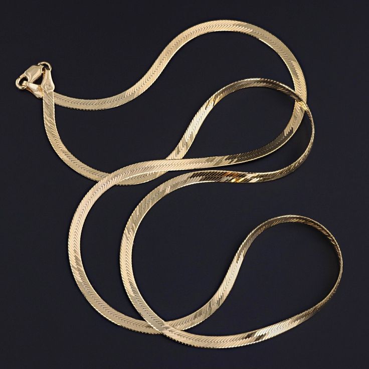 This vintage necklace (circa 1980-1990) features a chain of 14k gold herringbone links. The piece measures 24 inches long and weighs 8.4 grams. It is in great condition. Materials: 14k gold. Yellow Gold Herringbone Necklace With Link Chain, Yellow Gold Herringbone Link Necklace, Classic Gold Link Herringbone Necklace, Gold Classic Herringbone Link Necklace, Gold Herringbone Chain Necklace For Formal Occasions, Elegant Gold Herringbone Necklace With Curb Chain, 14k Yellow Gold Herringbone Chain Necklace, Formal Gold Herringbone Necklace In 14k Gold, Formal Gold-tone Snake Chain Necklace