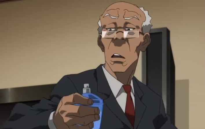 an older man in a suit and tie holding a blue bottle with something on it