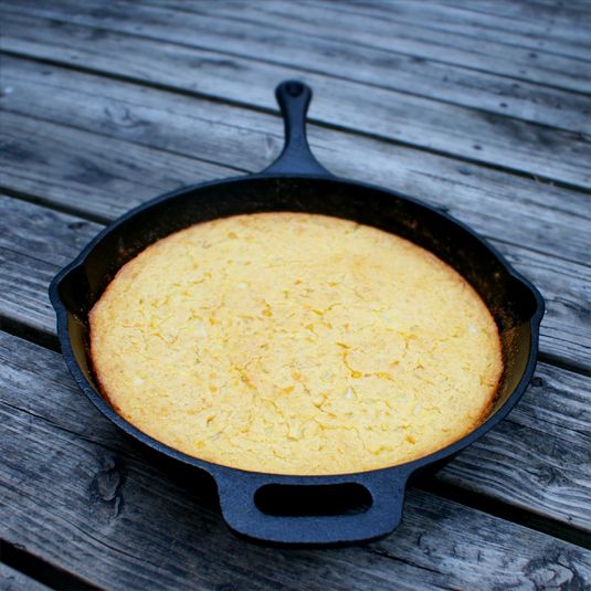 a cast iron skillet sitting on top of a wooden table