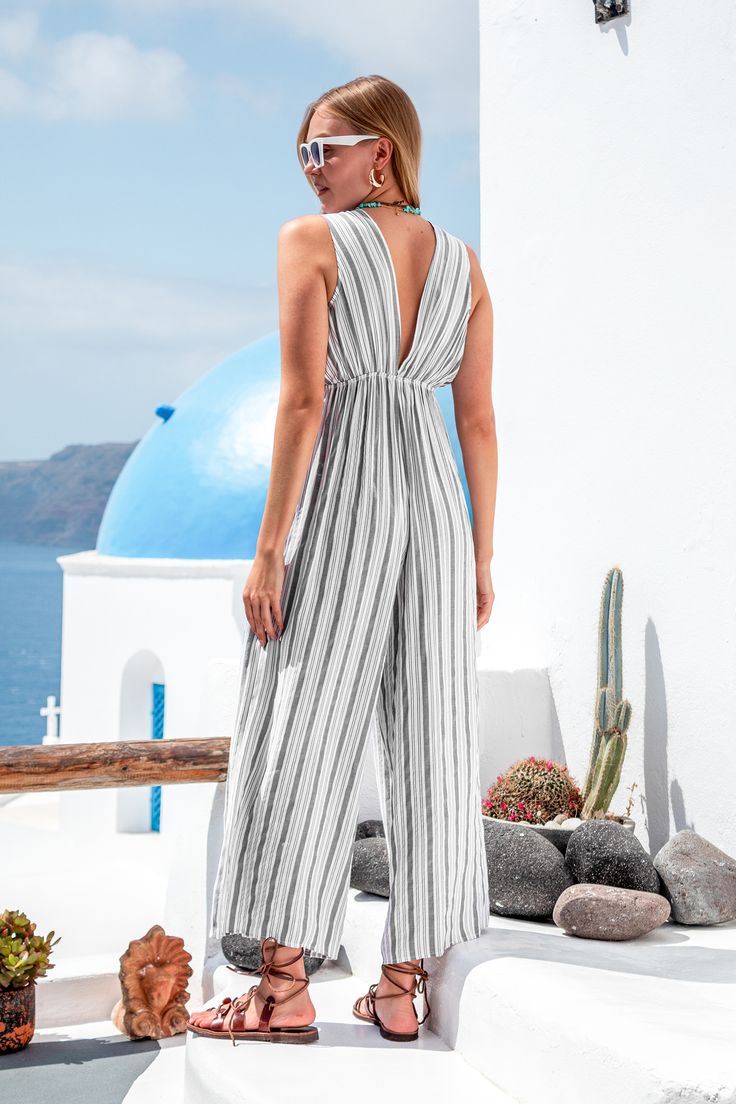 Get ready to make a statement in our Striped Tassel Wide Leg Jumpsuit! Featuring vibrant stripes and playful tassel details, this jumpsuit effortlessly combines style and fun for any summer adventure. Product code: CAA13E4E015BC Features:  Woven Plunging V-neckline Wide straps Tassel self-tie waist Wide leg Pattern: Stripes Wash Method: Regular Wash Material: 100%POLYESTER. Chic Striped Jumpsuits And Rompers For Summer, Striped Sleeveless Jumpsuits And Rompers For Spring, Vacation Beach Overall Jumpsuits And Rompers, Beachwear Overalls And Rompers For Beach, Sleeveless Striped Jumpsuits And Rompers For Spring, Striped Overalls Jumpsuits For Spring, Casual Striped Jumpsuits And Rompers For Summer, Striped Sleeveless Jumpsuit For Spring, Striped Summer Jumpsuits And Rompers For Vacation