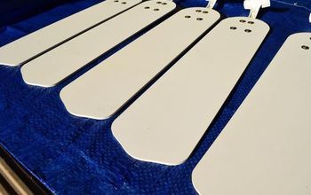 five white wooden tags sitting on top of a blue cloth