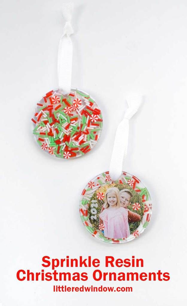 two christmas ornaments are hanging on a white background with the words sprinkle resin christmas ornaments