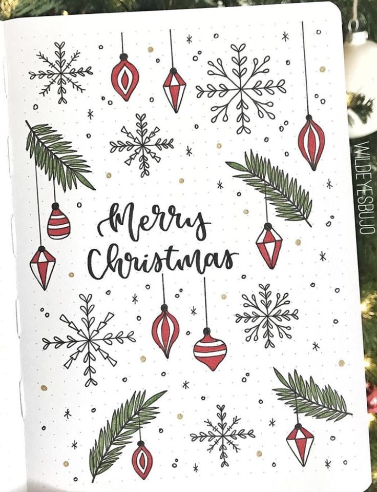 a christmas card with ornaments hanging from it