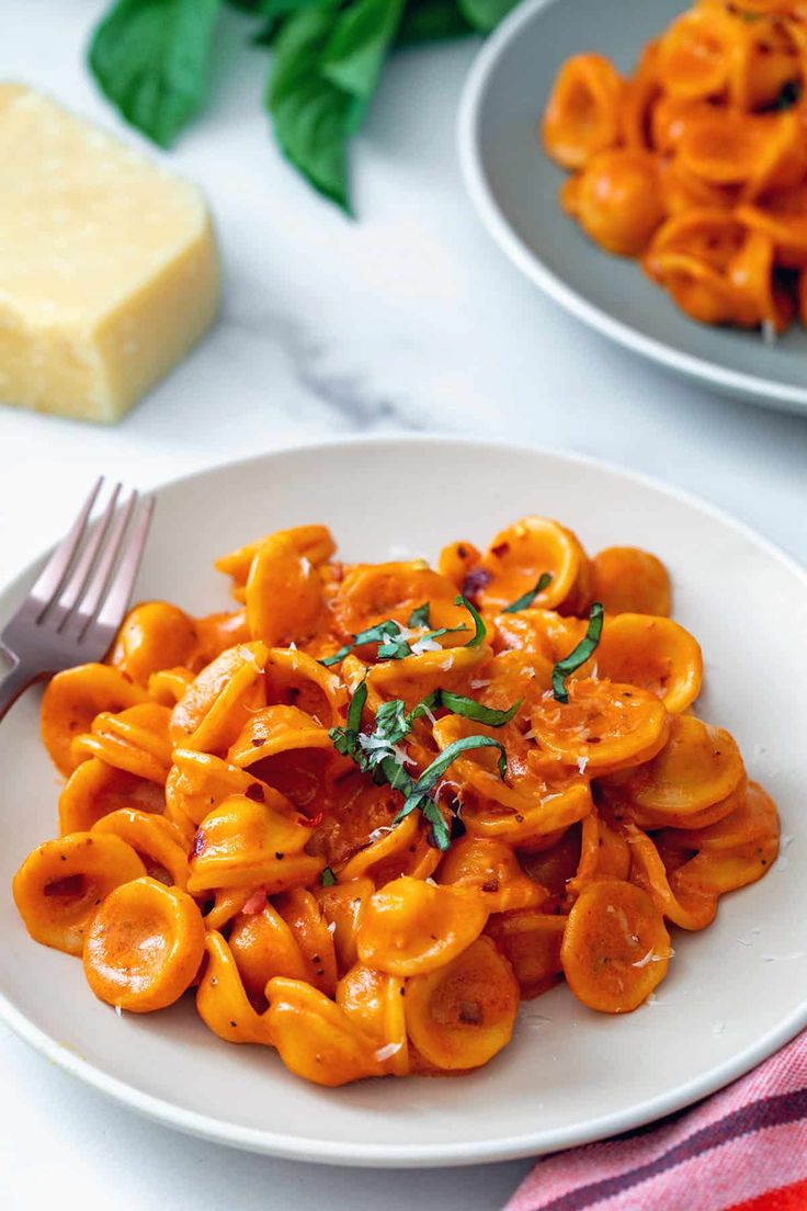 a white plate topped with pasta covered in sauce