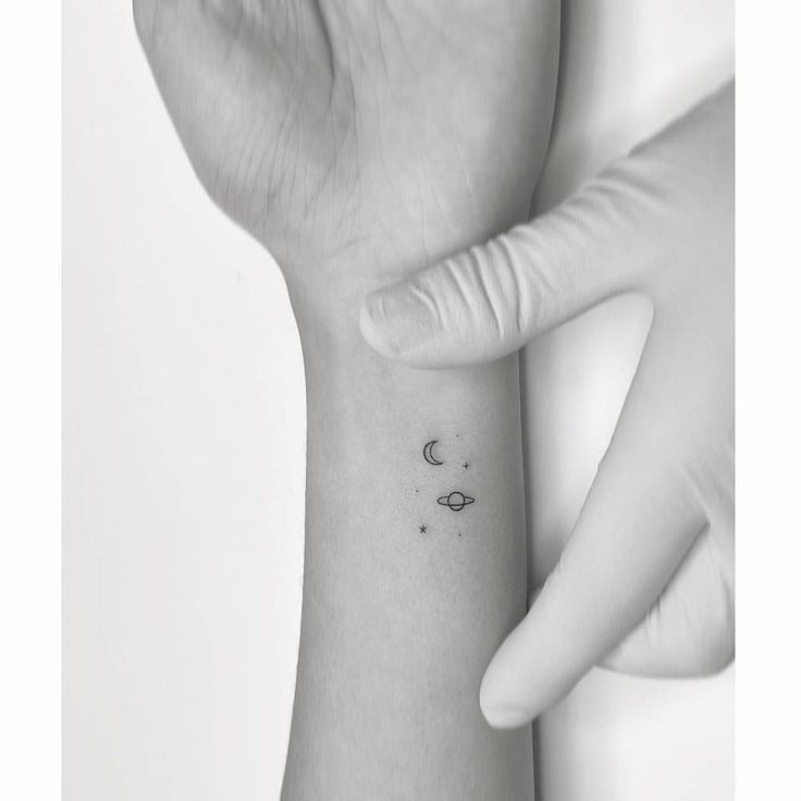 a person's arm with a small wrist tattoo on the left side of their hand