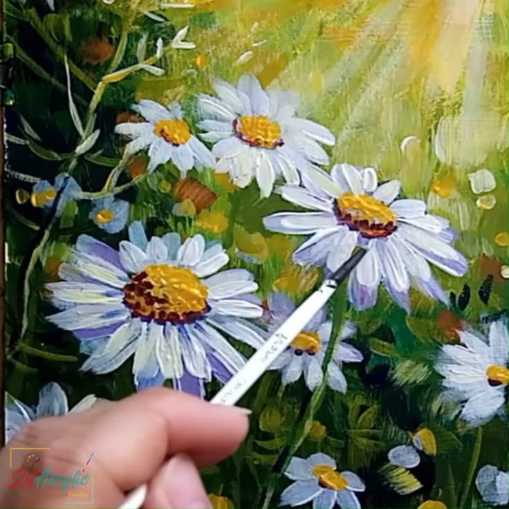 someone is painting daisies in the grass