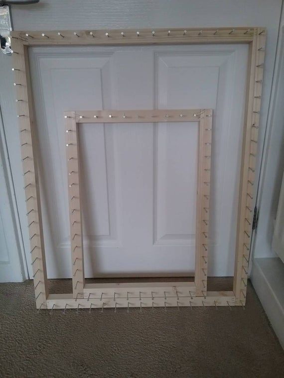 an empty white door in the corner of a room next to a window with beaded trim