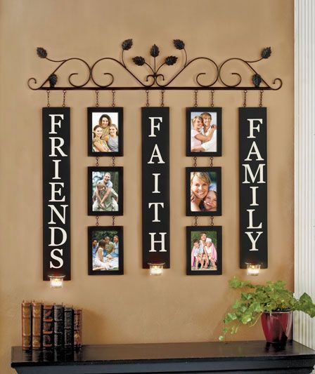 a family photo hanging on the wall above a mantle with candles and pictures attached to it