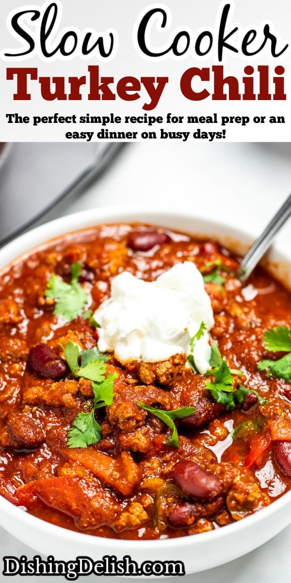 slow cooker turkey chili recipe in a bowl with sour cream and cilantro