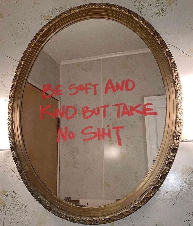 a mirror that has some writing on the side of it with red ink in it