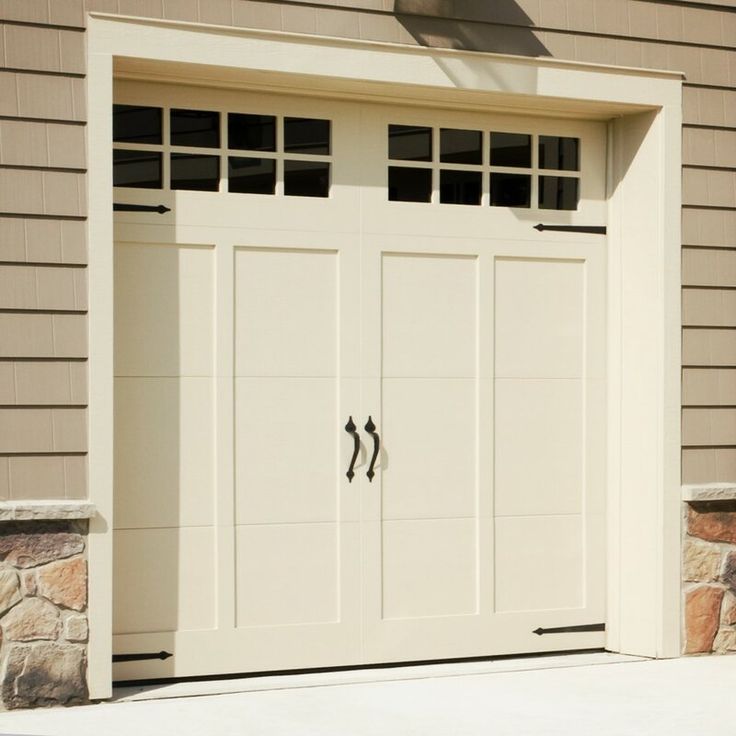 a white garage door with two windows on the side