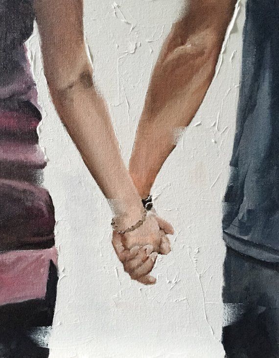 two people holding hands while standing next to each other