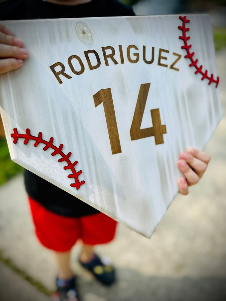 This personalized home plate it painted white and burned to give it a rustic look. Edges are routed with laser cut baseball seams on it. Parade Float Ideas Baseball, Senior Night Baseball Ideas, Baseball Bedroom For Boys, Baseball Senior Night Ideas, Senior Night Decorations, Dugout Mom, Redwood House, Baseball Party Decor, Royal Blue Centerpieces