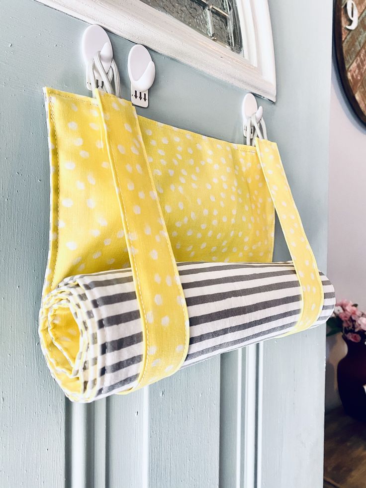 a yellow and white towel hanging on the wall