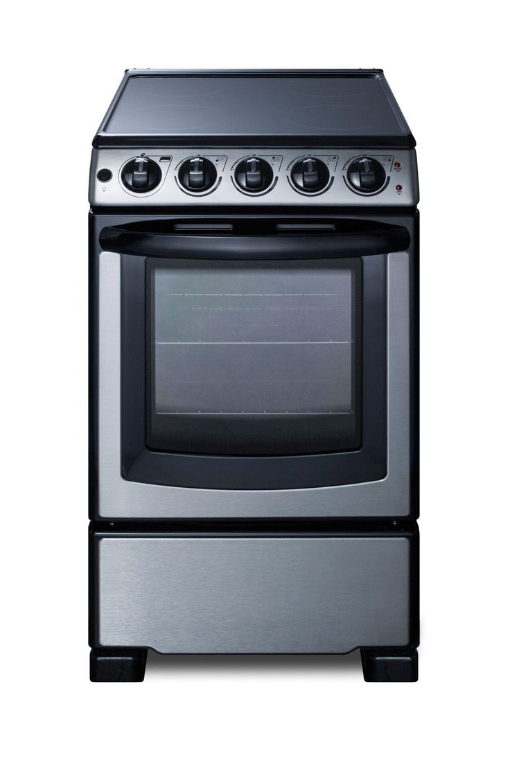 a silver stove top oven sitting next to a white wall