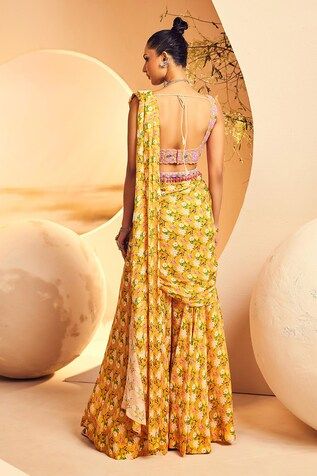 Yellow chinon chiffon pre-draped sharara saree with floral print. Paired with a padded blouse with floral geometric pattern hand embroidery using japanese beads and cutdana and embellished belt. - Aza Fashions Fitted Draped Traditional Wear For Festivals, Draped Blouse Piece For Festivals, Fitted Draped Choli For Diwali, Fitted Summer Traditional Wear With Traditional Drape, Fitted Draped Sharara With Pallu, Fitted Draped Sharara With Dupatta, Fitted Draped Saree For Festivals, Fitted Draped Sets For Navratri, Fitted Draped Sets For Festivals