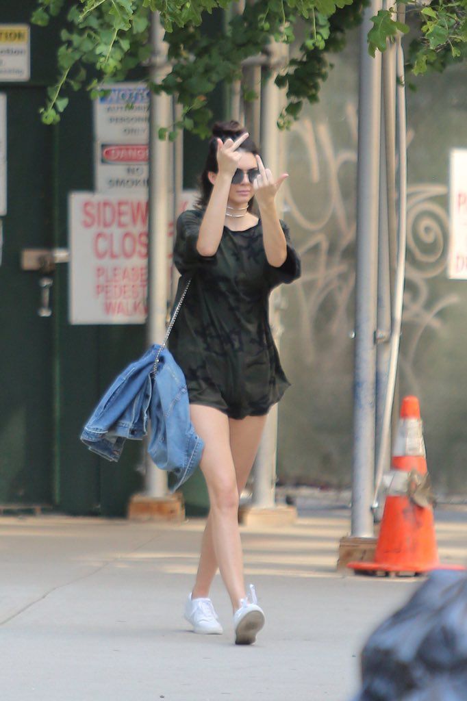 a woman walking down the street while talking on her cell phone