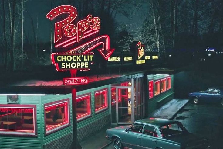 a neon sign that reads boo's chock lit shoppe