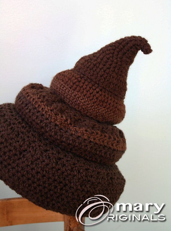 a brown knitted hat sitting on top of a wooden chair