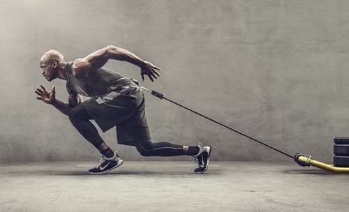 a man running with a stick in his hand