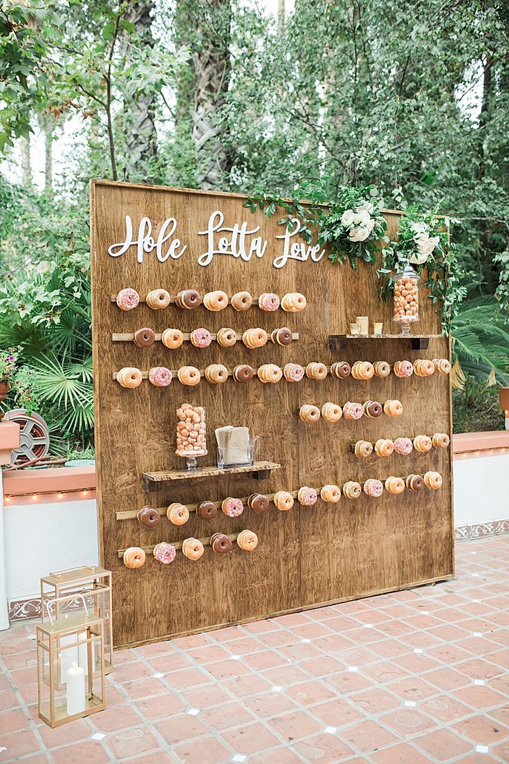 a wooden sign with donuts on it