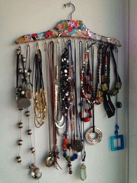 a bunch of necklaces hanging on a wall