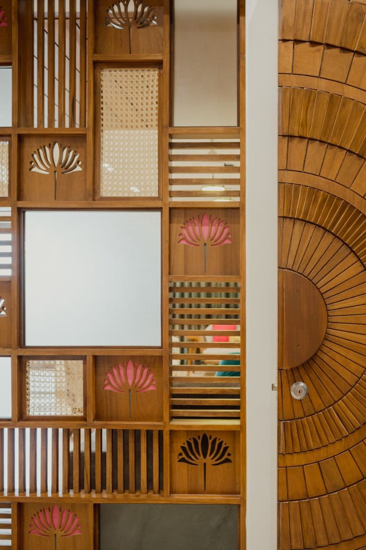 a room with wooden paneling and pink flowers on the wall