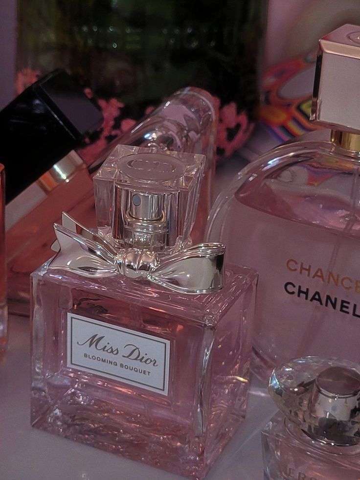 three perfume bottles sitting on top of a table