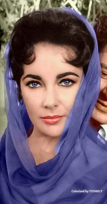 an old photo of a woman with blue eyes and a man in the background wearing a headscarf