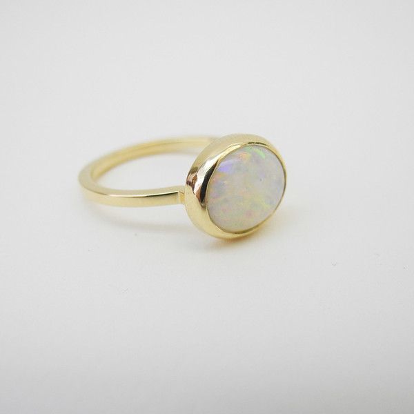 Modern Yellow Gold Moonstone Ring For Wedding, Luxury Round Opal Rings, Modern Yellow Gold Moonstone Wedding Ring, Polished Round Moonstone Ring In Fine Jewelry Style, Polished Moonstone Ring In Fine Jewelry Style, Classic White Opal Ring With Polished Finish, Polished Moonstone Fine Jewelry Ring, Elegant Round Opal Ring For Formal Occasions, Elegant Round Opal Ring For Formal Events