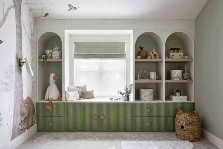 a green and white nursery room with shelves