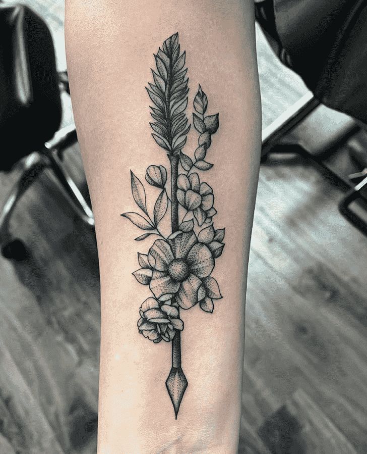 a black and white photo of a flower tattoo on the right leg with an arrow