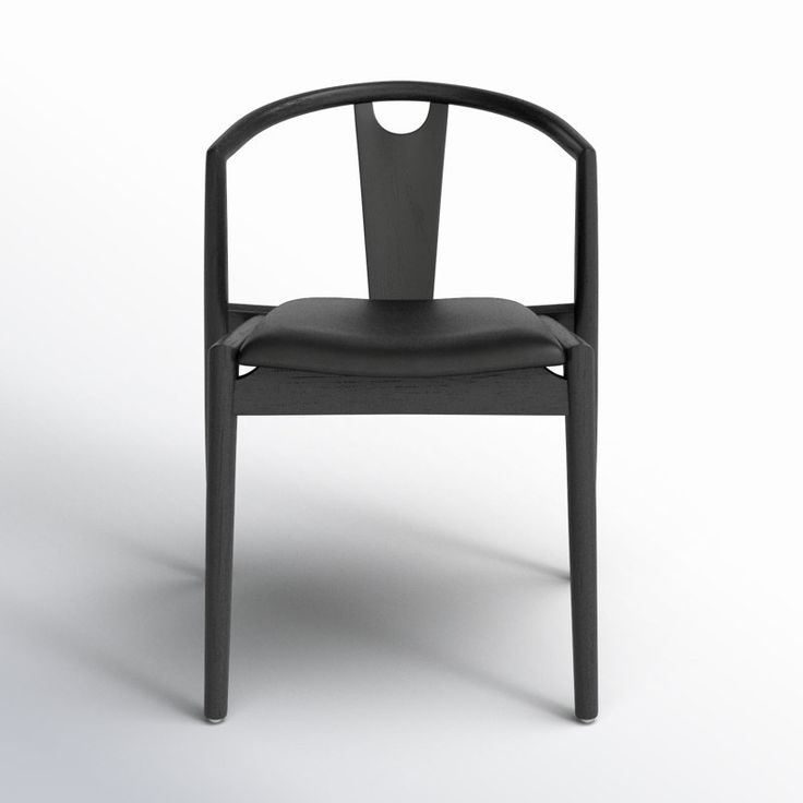 a black plastic chair with an open back and arm rests on a white surface in front of the camera