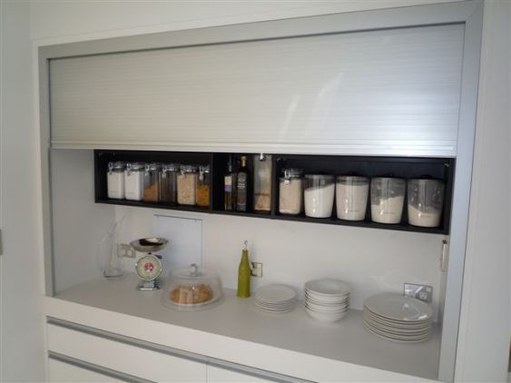 the shelves in the kitchen are filled with dishes and condiments for making food