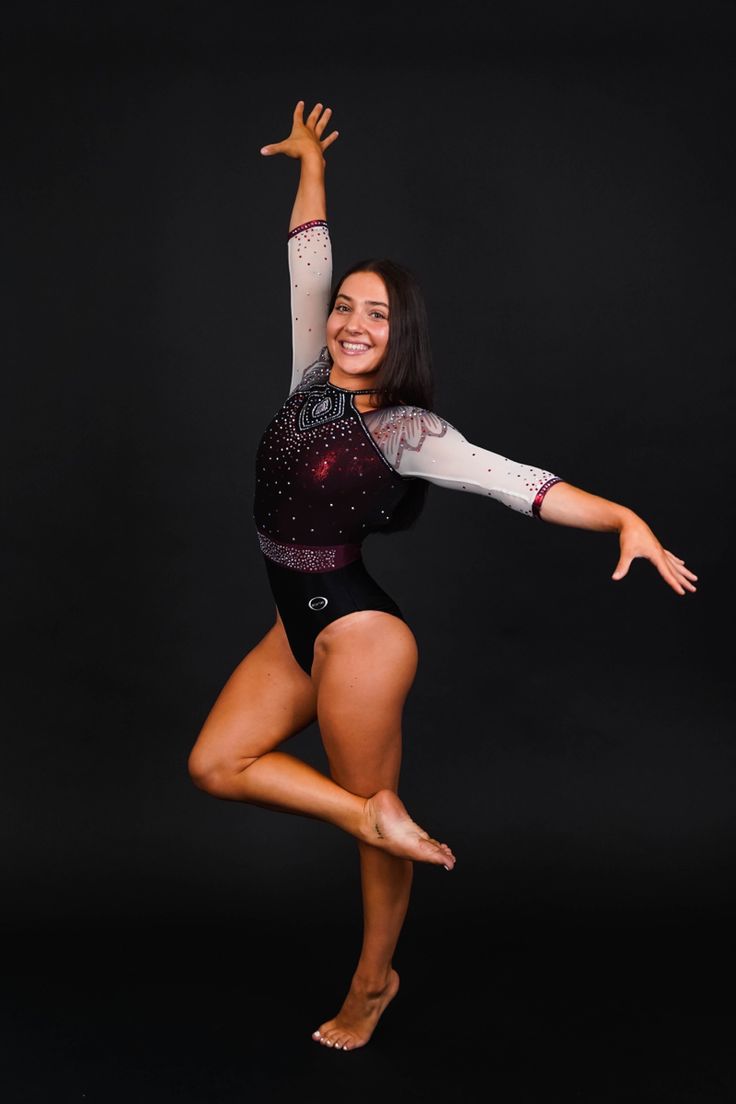 a woman in a leotard doing a handstand