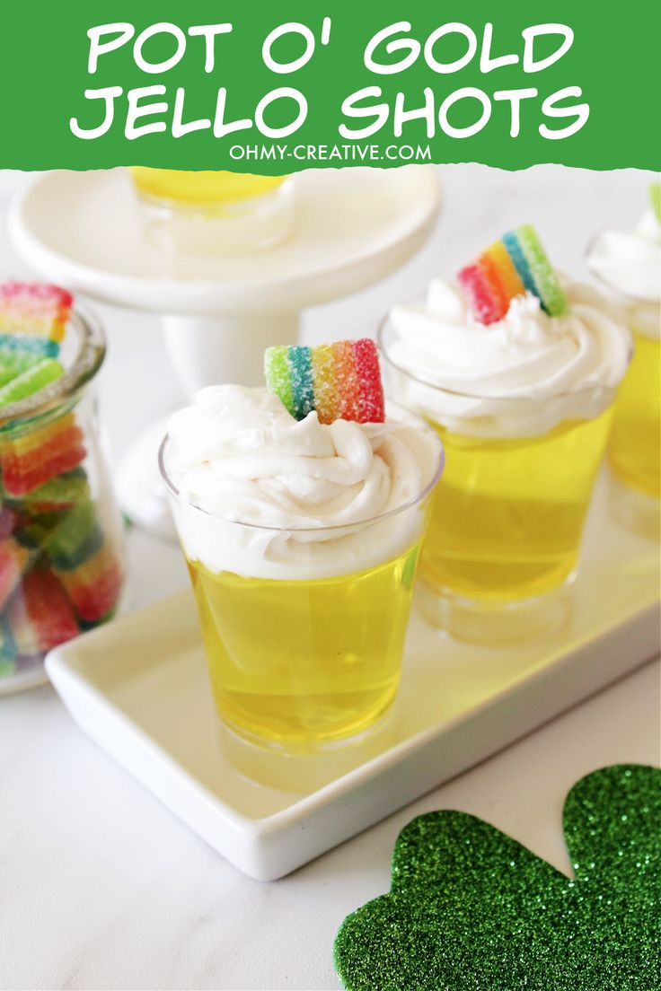 there is a cupcake with white frosting and rainbow decorations on the top that says pot o'gold jello shots