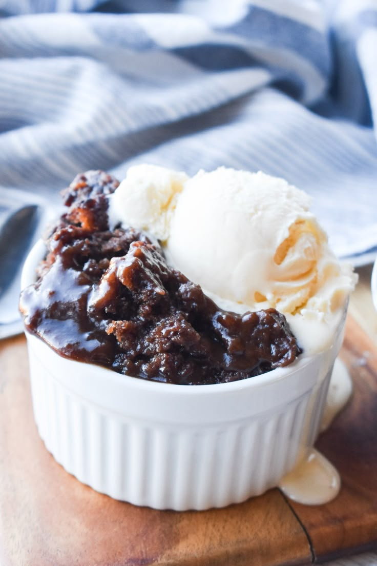 a bowl filled with ice cream on top of a wooden cutting board