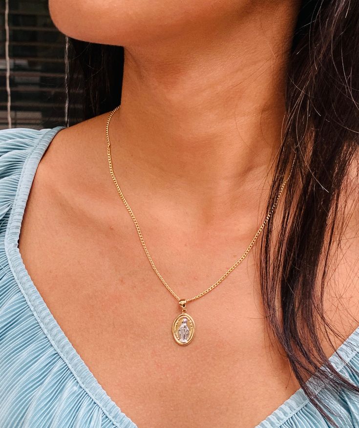 "Embrace the blessings of faith and grace with our Miraculous Mary charm necklace. 🌹🕊️ Let this exquisite charm embody the divine protection and intercession of the Virgin Mary. Wear it as a symbol of hope, strength, and unwavering belief in miracles. Carry the spirit of Mary's compassion and love wherever you go.  Chain Options and Lengths are available below. Chain thickness: 2mm For KIDS- Women: We recommend 16\" For Women: 18\"  For MEN: We recommend 24\" Material: 18 Karat Gold Filled, Hy Spiritual Jewelry With Miraculous Medal For Blessing, Miraculous Medal Round Pendant Necklace As Gift, Spiritual Jewelry With Miraculous Medal As Gift, Spiritual Personalized Necklace With Oval Pendant, Elegant Miraculous Medal Necklace, Spiritual Round Pendant Locket, Spiritual Miraculous Medal Charm Necklace As Gift, Miraculous Medal Round Pendant Necklace For Gift, Gold Necklace With Miraculous Medal For Memorial